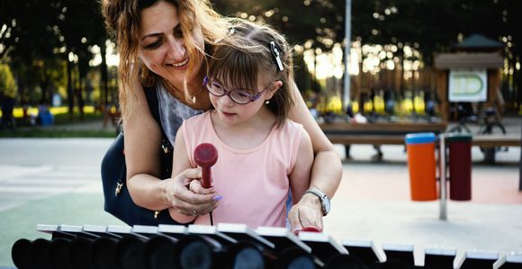 Woman and female child playing xylophone