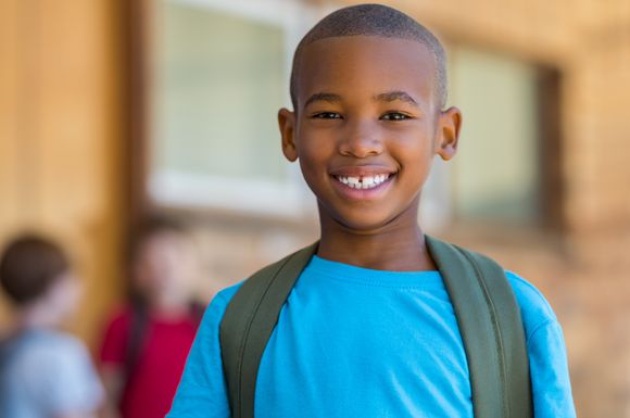 Boy with backpack on in classroom